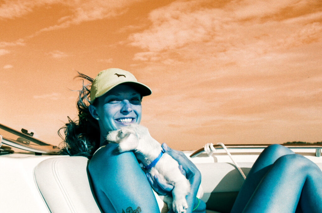 Lomography Lomochrome Turquoise 35mm Film - girl on a boat on Lake Lanier with a dog