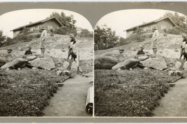 1912 stereograph showing construction scene of a hillside house near Silver Lake Reservoir, with dirt grading in foreground.