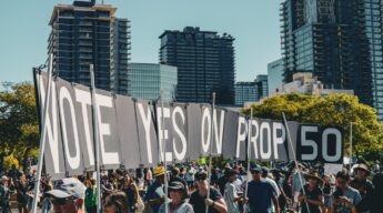 No Kings Day San Diego October 18 2025 - a crowd with a sign that says "vote yes on prop 50"