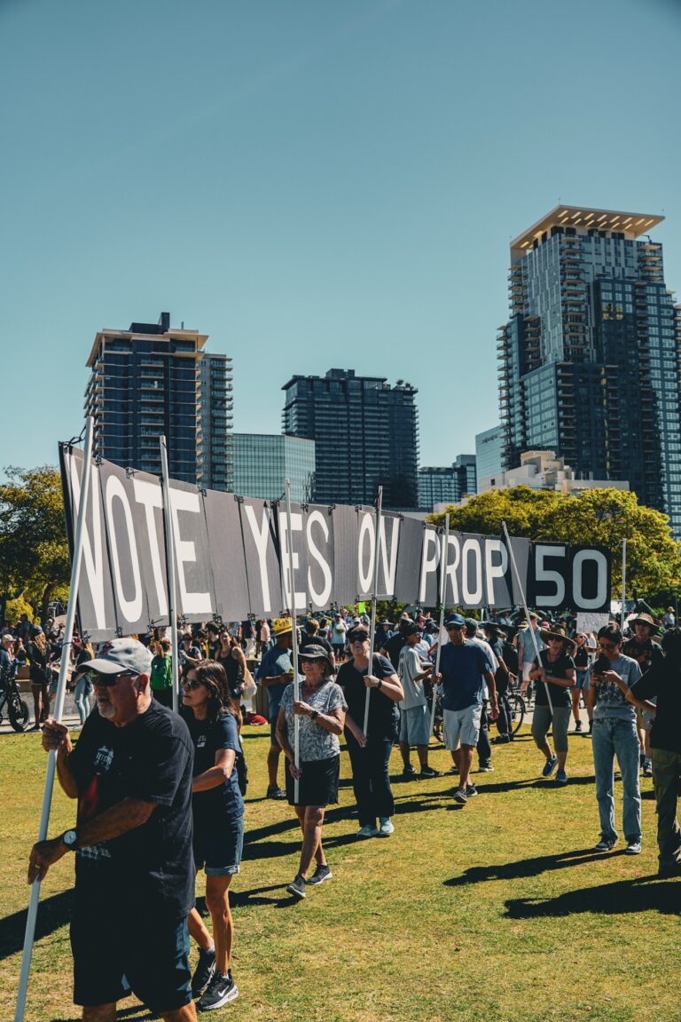 No Kings Day San Diego October 18 2025 - a crowd with a sign that says "vote yes on prop 50"