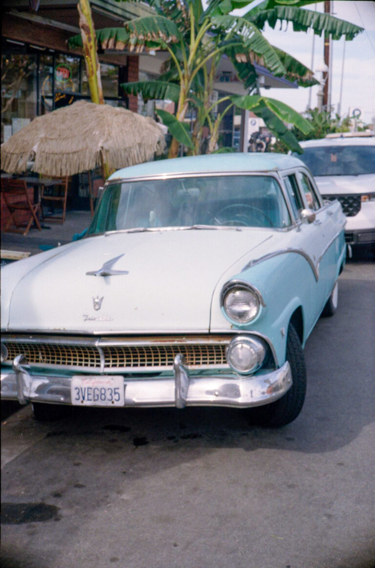 vintage Ford Fairlane side profile parked next to jewelry shop Ocean Beach San Diego, Yashica Electro 35