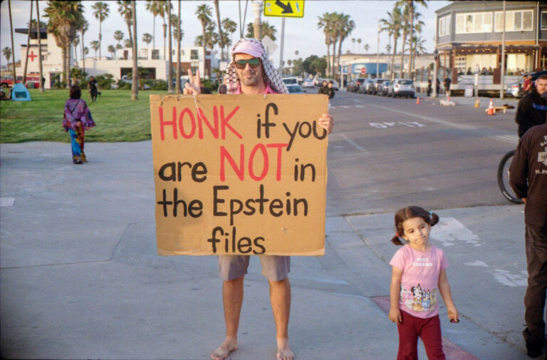 man holding protest sign at Ocean Beach San Diego boardwalk, Yashica Electro 35 street photography