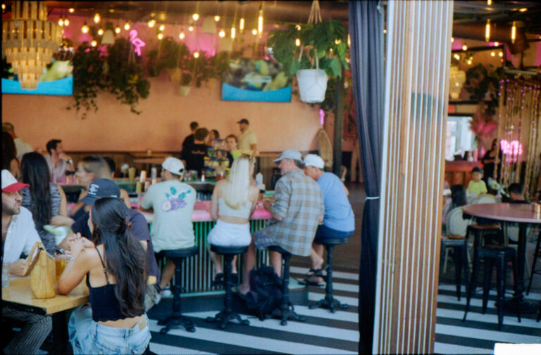 interior of Flamingo Deck bar Pacific Beach San Diego with tropical decor and string lights, Yashica Electro 35