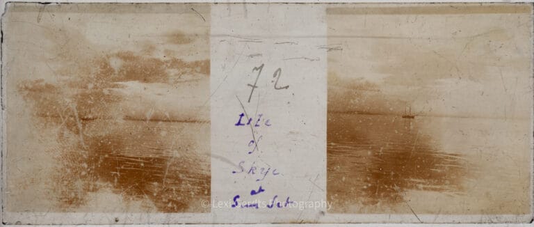 Vérascope Richard glass slide numbered 72 and captioned "Isle of Skye at Sun Set" showing a boat silhouetted on calm water at dusk on the Isle of Skye, Scotland. From Empress Eugenie Verascope Richard collection.