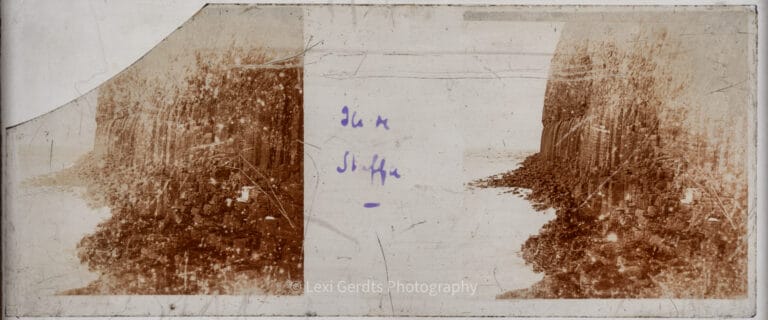 Stereoscopic glass slide with cut corners showing a variant view of the basalt cliffs on the Isle of Staffa, Inner Hebrides, Scotland, captured on a Vérascope Richard glass plate. From Empress Eugenie Verascope Richard collection.