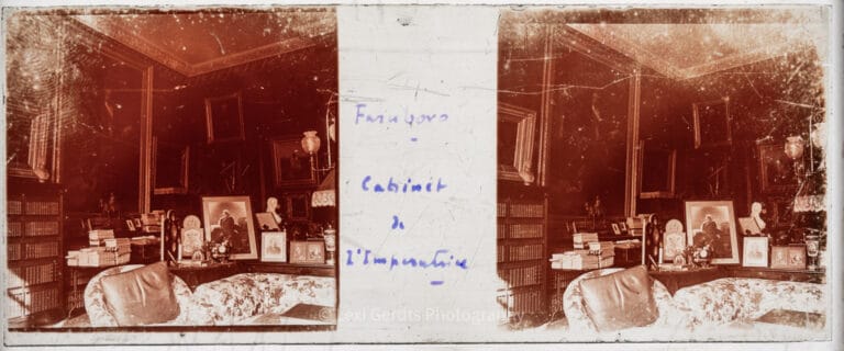 Stereoscopic glass plate captioned "Farnboro – Cabinet de l'Impératrice" showing Empress Eugénie's private study at Farnborough Hill, Hampshire, filled with books, framed photographs, portrait busts, and paintings. From Empress Eugenie Verascope Richard collection.