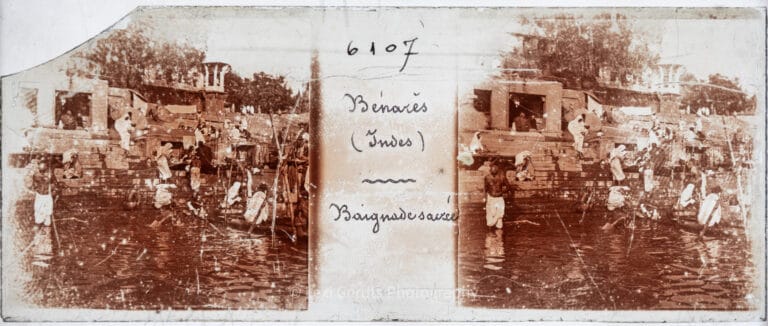 Antique stereoscopic glass slide numbered 6107 and captioned "Bénarès (Indes) – Baignade sacrée" showing sacred bathing along the ghats of Varanasi on the Ganges River, India. From Empress Eugenie Verascope Richard collection.