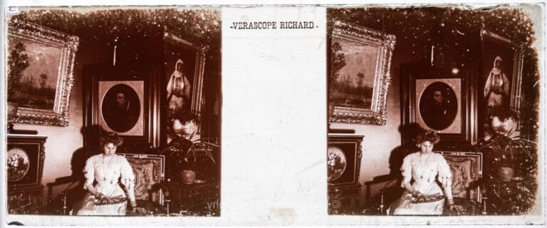 Antique Vérascope Richard stereoscopic glass plate showing a woman in white seated among portraits in the Bonaparte gallery at Farnborough Hill, Hampshire, on a Richard-branded 45x107mm blank plate. From Empress Eugenie Verascope Richard collection.