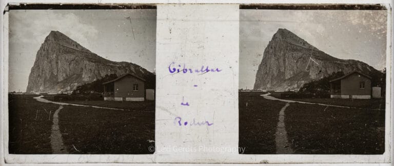 Stereoscopic glass slide captioned "Gibraltar – Le Rocher" showing the Rock of Gibraltar behind a house, photographed from a boat in the harbour, circa early 1900s. From Empress Eugenie Verascope Richard collection.