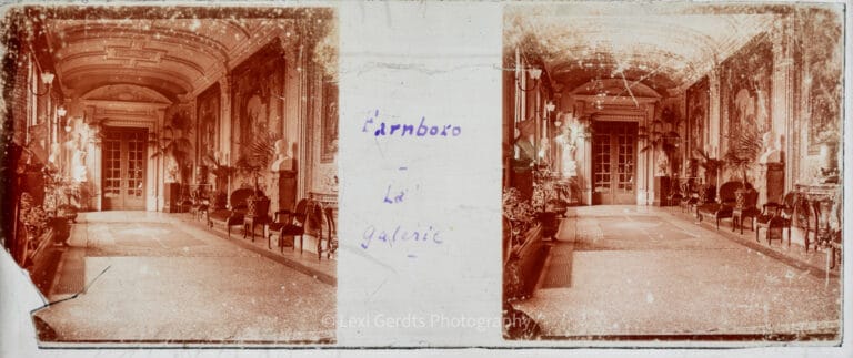 Stereoscopic glass slide captioned "Farnboro – La Galerie" showing a variant exposure of the ornate long gallery at Farnborough Hill, Hampshire, Empress Eugénie's residence, with arched ceiling and tapestries. From Empress Eugenie Verascope Richard collection.