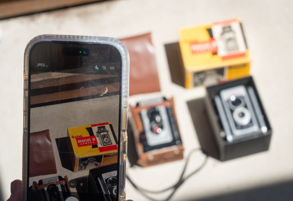 Overhead flat-lay of the Kodak Duaflex III and Argus Argoflex 75 with a phone, vintage 620 camera shoot